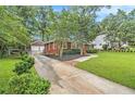 Beautiful brick home with a long driveway leading to a detached two-car garage at 2057 Cambridge Ave, Atlanta, GA 30337