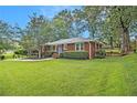 Traditional brick home with a neatly landscaped front yard and mature trees at 2057 Cambridge Ave, Atlanta, GA 30337