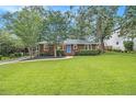 Charming brick home featuring a well-manicured lawn and inviting blue front door at 2057 Cambridge Ave, Atlanta, GA 30337