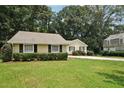 Well-kept yellow home featuring neat landscaping and lush green grass at 2466 Country Club Dr, Conyers, GA 30013