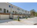 Contemporary townhome community with garages, patios, and well-manicured landscaping at 161 Brush Creek Ct, Stockbridge, GA 30281