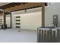 Garage with modern garage door featuring windows, air conditioning unit in view at 161 Brush Creek Ct, Stockbridge, GA 30281