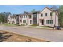 New construction townhomes featuring manicured lawns and modern architectural details at 161 Brush Creek Ct, Stockbridge, GA 30281