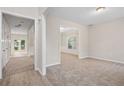 Bright, spacious living area featuring neutral paint, new carpet and multiple doorways offering easy access at 2040 Village Green Dr, Fairburn, GA 30213
