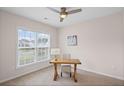 Bright bedroom featuring a large window, ceiling fan, neutral color palette, and carpeted floors at 4322 Braden Nw Ln, Kennesaw, GA 30144