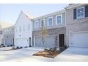 Exterior shot of new townhome with attached garage and landscaping at 905 Agate Ln, Lawrenceville, GA 30043