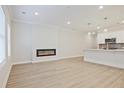 Open-concept living room with fireplace flowing into kitchen at 905 Agate Ln, Lawrenceville, GA 30043