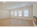 Spacious living room with modern lighting, fireplace, and vinyl flooring at 905 Agate Ln, Lawrenceville, GA 30043