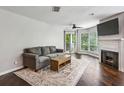 Well-lit living room with comfortable sofa, fireplace, and hardwood floors at 244 13Th Ne St # 302, Atlanta, GA 30309