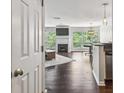 Open-concept living room with fireplace, hardwood floors, and a dining area at 244 13Th Ne St # 302, Atlanta, GA 30309