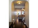 Hallway with dark wood floors leading to the living room and staircase at 5715 Radford Loop # 15, Fairburn, GA 30213