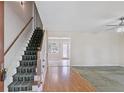 Spacious foyer with hardwood floors and a staircase leading to the upper level at 98 Little John Way, Douglasville, GA 30134