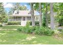 Charming home with a welcoming front porch surrounded by mature trees at 98 Little John Way, Douglasville, GA 30134
