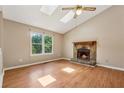 Inviting living room with a stone fireplace, vaulted ceilings, skylights, and wood-look floors at 3450 Saddleton Way, Douglasville, GA 30134