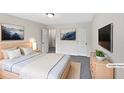Staged bedroom with a bed, dresser, and mounted TV at 8332 Mountain Pass, Riverdale, GA 30274