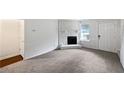 Bright living room features a fireplace and new carpet at 8332 Mountain Pass, Riverdale, GA 30274