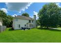Expansive green backyard with a patio set, lush lawn, and mature trees, ideal for outdoor activities at 1055 Havenstone Walk, Lawrenceville, GA 30045