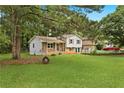 Spacious backyard with lush lawn and mature trees, offering ample room for outdoor activities at 135 Buckhurst Way, Atlanta, GA 30349