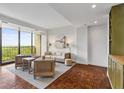 Cozy living room showcasing a full wall of windows with picturesque outdoor views at 145 15Th Ne St # 1209, Atlanta, GA 30309