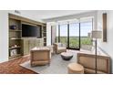 Bright and airy living room featuring built-in shelves and an expansive view at 145 15Th Ne St # 1209, Atlanta, GA 30309