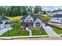 Charming two-story home with a light brick exterior, lush lawn, and a large drive at 2455 Bleckley Pl, Cumming, GA 30041