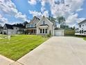 Charming two-story home with a light brick exterior, lush lawn, and a large drive at 2455 Bleckley Pl, Cumming, GA 30041