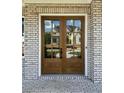 Elegant double front door with glass panels, framed by brick facade and white trim at 2455 Bleckley Pl, Cumming, GA 30041