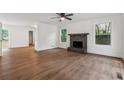 Spacious living room with hardwood floors, a classic fireplace, and bright windows at 2780 Northwood Court Sw Ct, Marietta, GA 30060