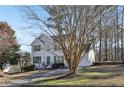 Charming two-story home with a well-manicured lawn, attached garage, and inviting curb appeal at 1056 Shadow Lake Dr, Lithonia, GA 30058