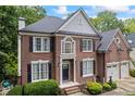 Beautiful brick home with a manicured lawn and two-car garage at 1547 Grove Arbor Ter, Dacula, GA 30019
