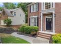 Traditional brick home featuring manicured landscaping and a charming front entry at 1547 Grove Arbor Ter, Dacula, GA 30019