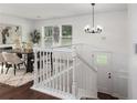 Bright dining area featuring a staircase, stylish chandelier, and modern decor at 932 Brian Ln, Forest Park, GA 30297