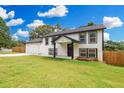 Charming two-story home with a lush green lawn and a spacious two-car garage at 932 Brian Ln, Forest Park, GA 30297