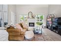 Bright living room with large windows, white fireplace, comfortable seating, and stylish decor at 2471 Cedar W Brk, Marietta, GA 30067