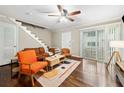 Bright living room featuring hardwood floors, staircase, sliding doors, and modern furnishings at 411 10Th Ne St # 6, Atlanta, GA 30309