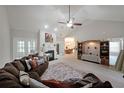 Spacious living room with vaulted ceiling, fireplace, large sectional sofa, and adjacent dining area at 450 Hunt Creek Dr, Acworth, GA 30101