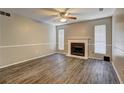 Spacious living room features a cozy fireplace and modern wood-look flooring at 5026 Brittany Dr, Stone Mountain, GA 30083