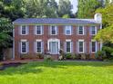 Traditional brick home with a well-maintained lawn, symmetrical design, and inviting curb appeal at 4512 Woodlawn Lake Dr, Marietta, GA 30068