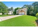 Charming brick and siding home with a spacious front yard and driveway at 7505 Brookwood Way, Cumming, GA 30041