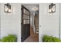 Open front door revealing a staircase and beautiful herringbone hardwood floors at 9165 Eves Cir, Roswell, GA 30076