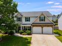 Two-story home with a two-car garage, landscaping, and combination brick and siding design at 105 Lanier Xing, Hiram, GA 30141