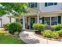 Charming front porch with stone accents, lush greenery, and a welcoming entrance at 105 Lanier Xing, Hiram, GA 30141