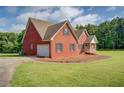 Side view of a brick house with an attached garage and well-maintained lawn at 172 Lakeview Dr, Newborn, GA 30056
