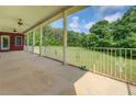 Covered back patio with decorative railing overlooking a grassy backyard at 172 Lakeview Dr, Newborn, GA 30056