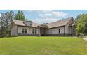 Lovely single story home with gray siding, stone accents, and a spacious green lawn at 411 Johnson Rd, Locust Grove, GA 30248