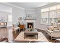 Cozy living room with a fireplace, bright windows, and comfortable seating arrangements at 1802 Lexington Green Pnes, Cumming, GA 30040