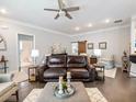 Comfortable living room featuring hardwood floors, ample seating, and lots of natural light at 1802 Lexington Green Pnes, Cumming, GA 30040