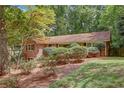 A quaint brick home with manicured bushes and a natural setting at 1693 Alderbrook Ne Rd, Atlanta, GA 30345