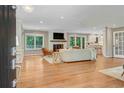 Open-concept living room with hardwood floors, fireplace, and access to the kitchen at 1693 Alderbrook Ne Rd, Atlanta, GA 30345