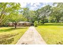 A lush green lawn and driveway leading up to the charming brick home at 5952 Medlock Ave, Austell, GA 30106